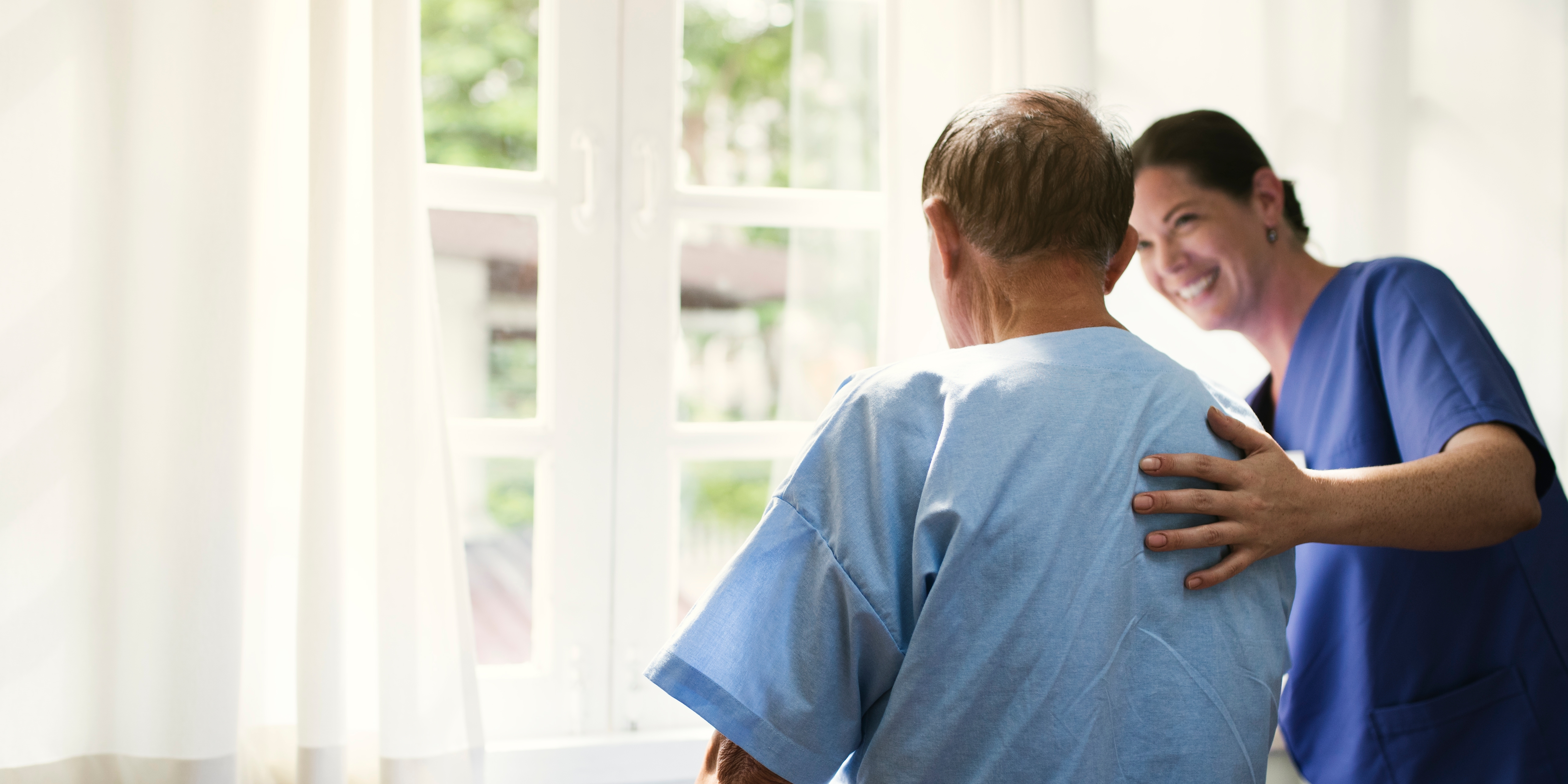 Nurse supporting patient to walk